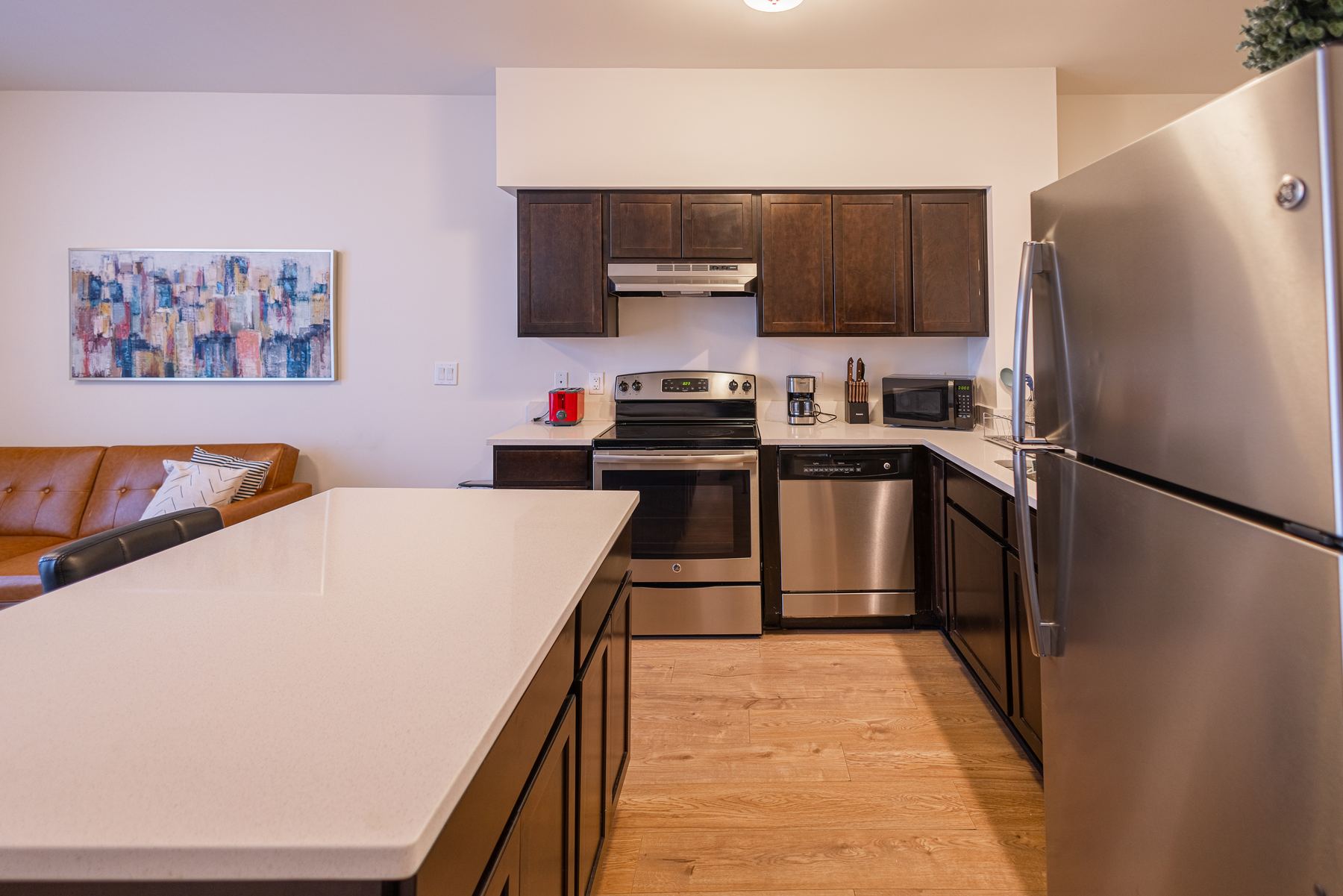 Kitchen open to the living room with stainless steel appliances