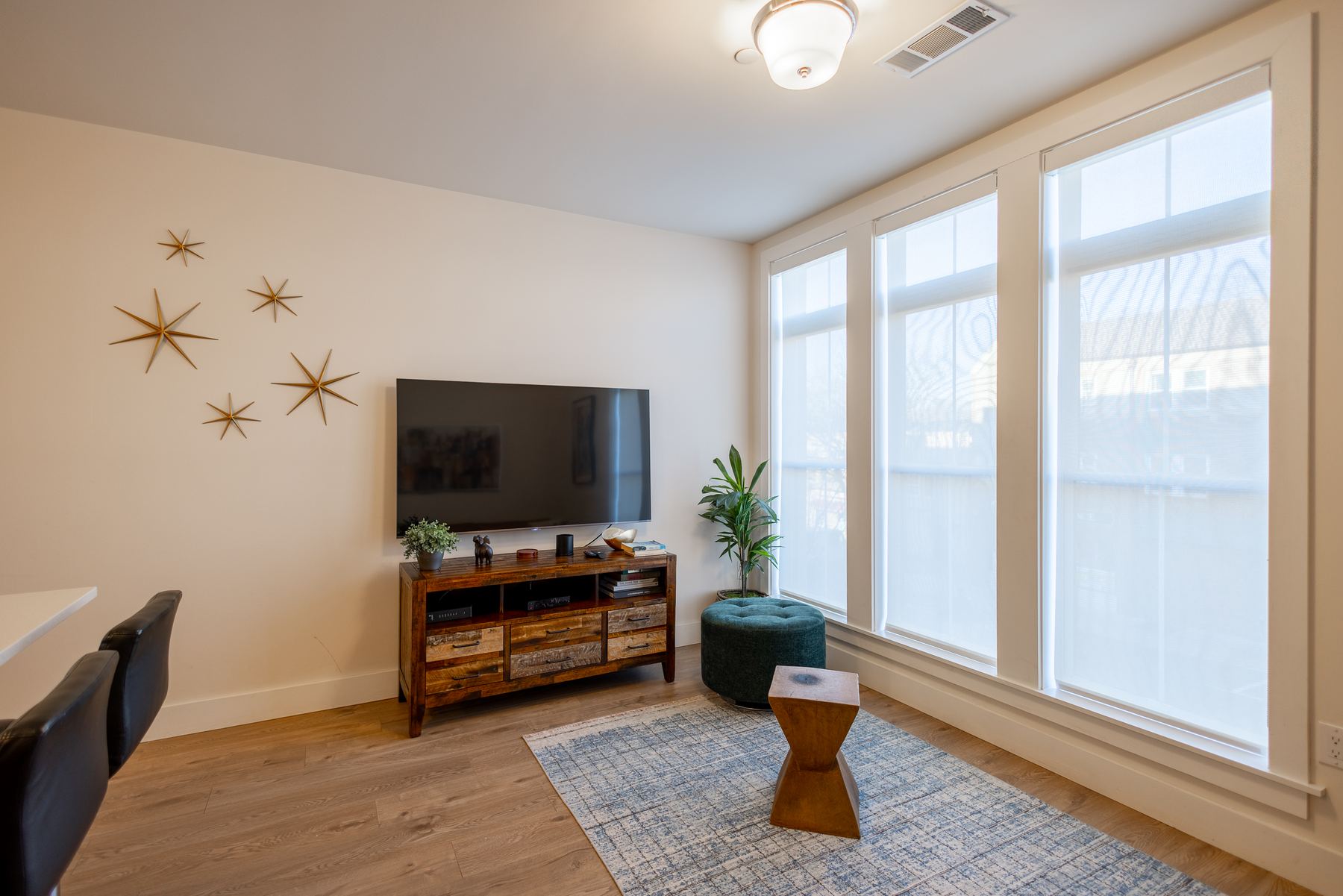 Living area with large windows and media console