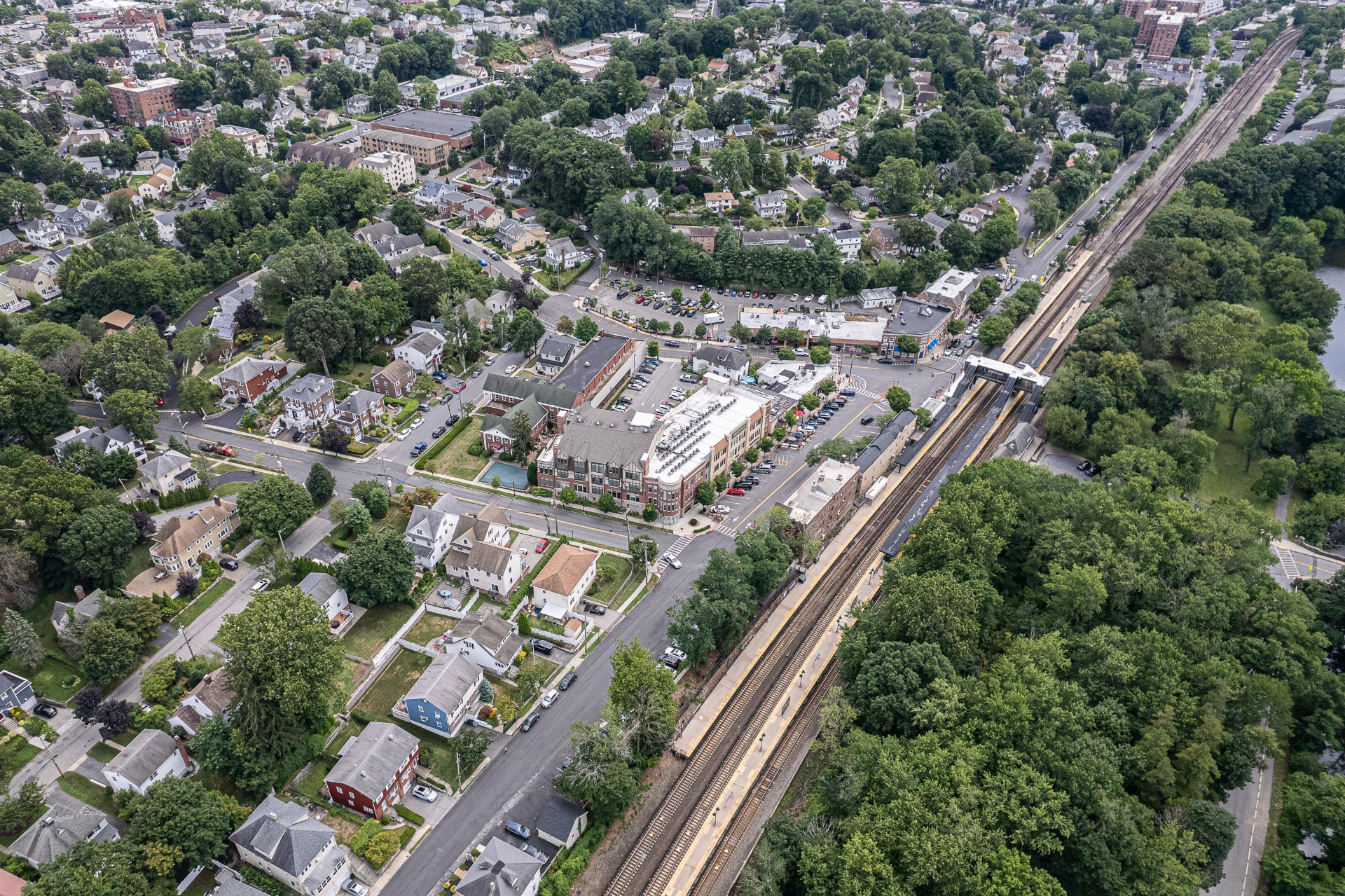 Aerial view of Crestwood village, tree-lined streets and the rail line