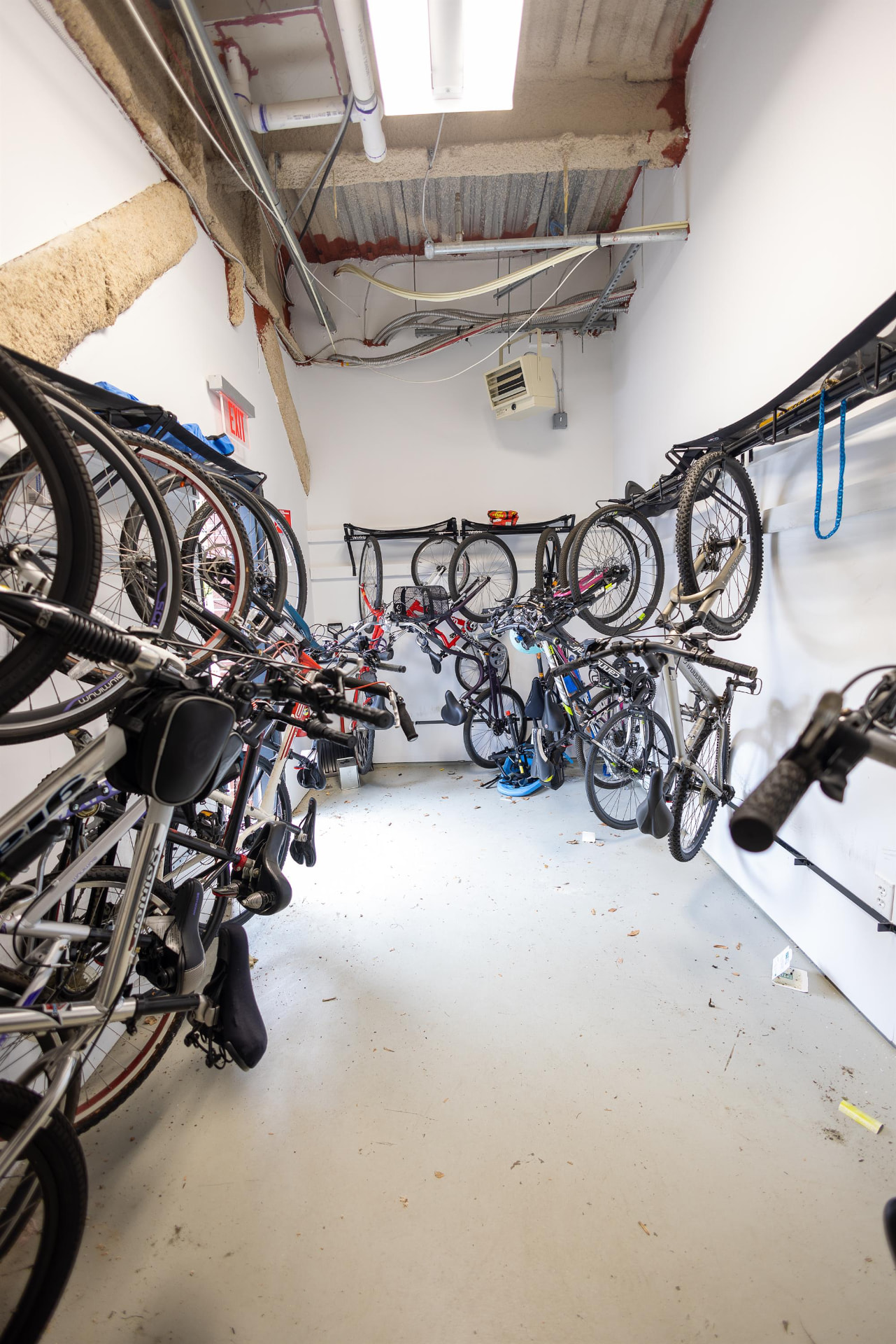 Secure indoor bicycle storage room with wall-mounted racks
